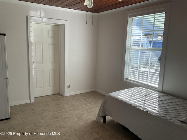 bedroom with multiple windows, baseboards, and light tile patterned floors