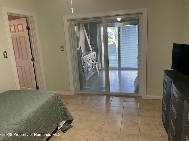 bedroom with access to exterior, baseboards, and light tile patterned floors