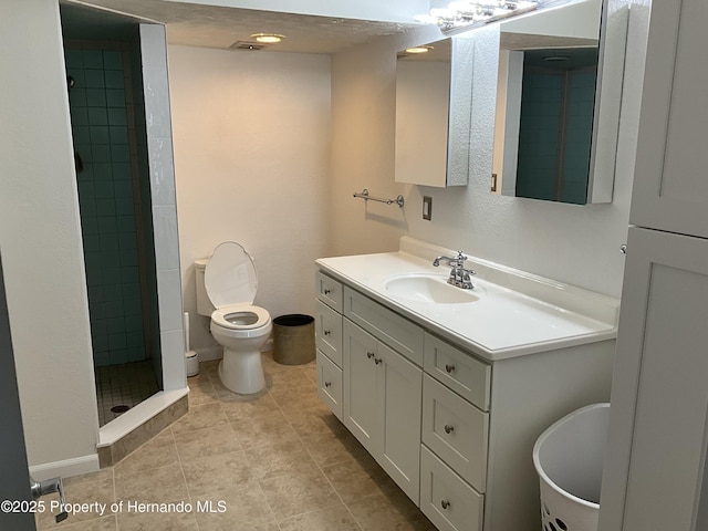 full bath with tile patterned flooring, toilet, a shower stall, and vanity