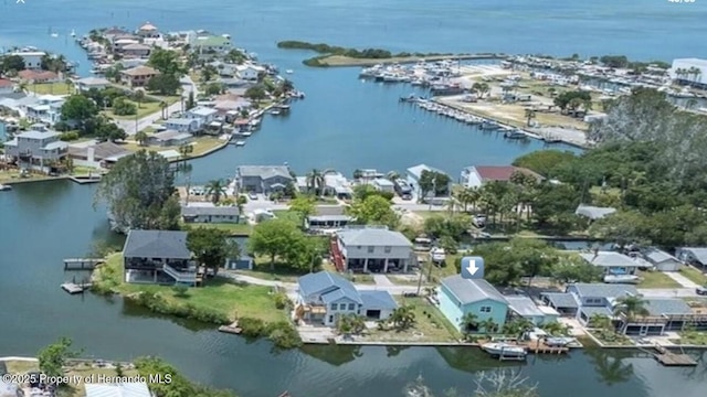 birds eye view of property with a water view and a residential view