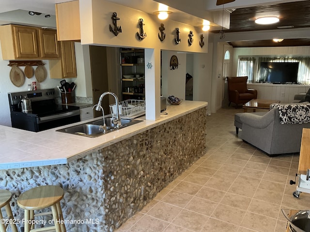 14208 Shiloh Ct, Hudson, FL 34667 - kitchen with electric range, a sink, light tile patterned floors, tile countertops, and open floor plan