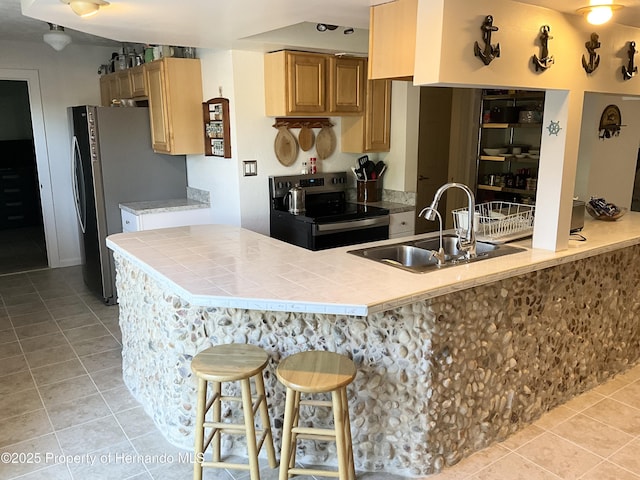 14208 Shiloh Ct, Hudson, FL 34667 - kitchen with electric stove, light tile patterned floors, a kitchen breakfast bar, a sink, and tile countertops