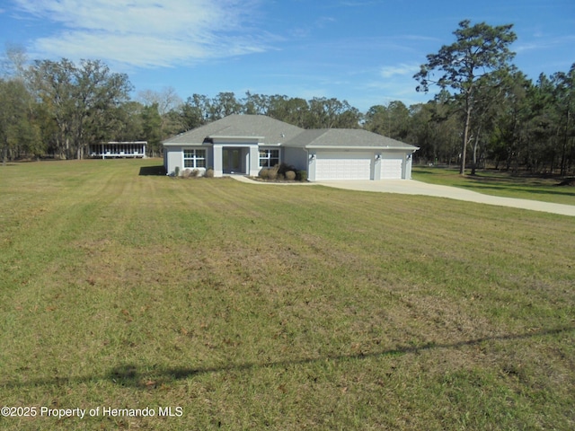 view of front facade featuring a garage, a front lawn, and concrete driveway