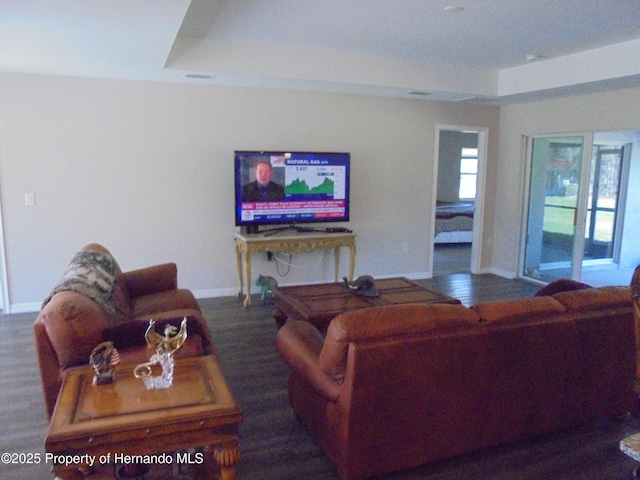 living area with baseboards and wood finished floors