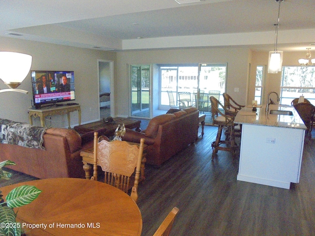 living area featuring visible vents and dark wood-type flooring