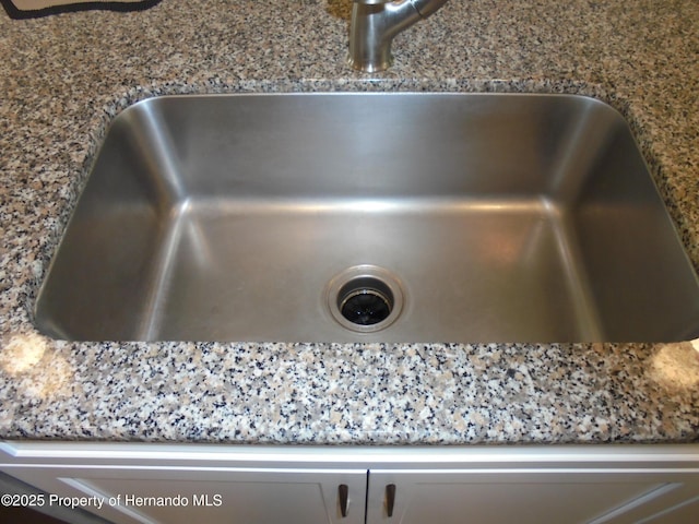 details with stone counters and a sink