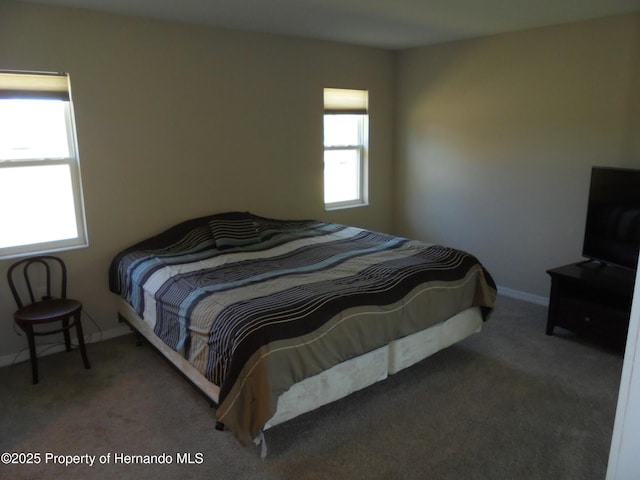 carpeted bedroom featuring baseboards