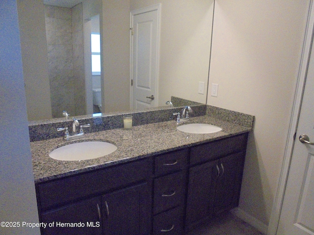 bathroom featuring double vanity and a sink