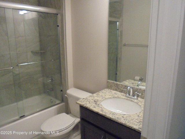 full bath featuring shower / bath combination with glass door, vanity, and toilet