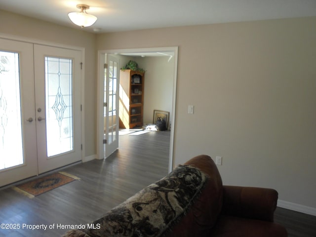 foyer entrance featuring french doors, wood finished floors, and baseboards