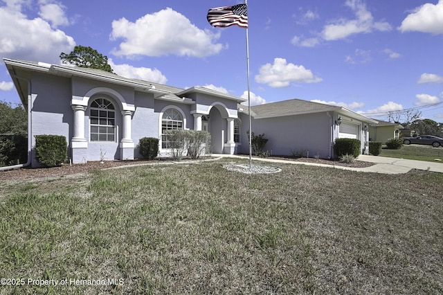 view of front of property with a garage, concrete driveway, a front lawn, and stucco siding