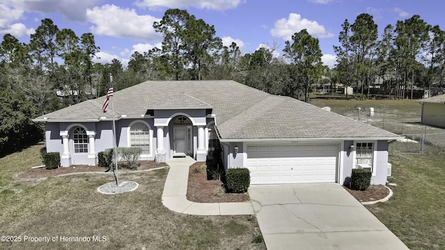 view of front of property with a garage, concrete driveway, and stucco siding