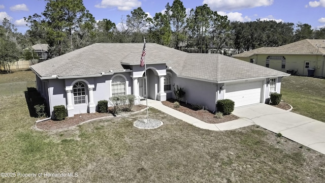 ranch-style home with driveway, a front lawn, an attached garage, and stucco siding