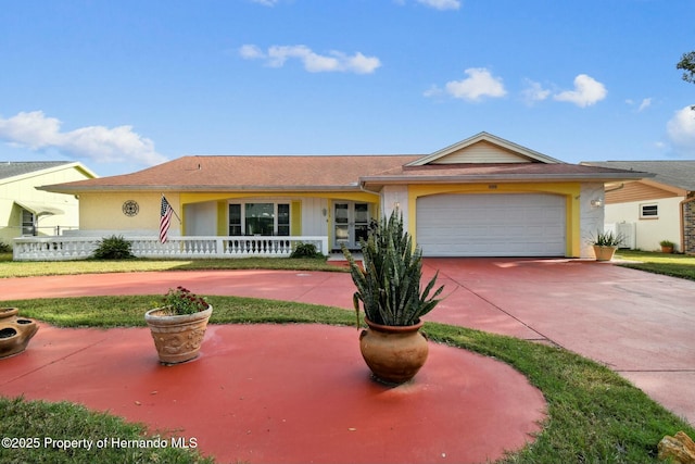 single story home with a garage, a porch, and stucco siding