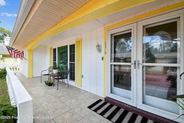 entrance to property with french doors and fence