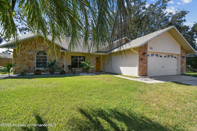 ranch-style home featuring a front lawn, stone siding, an attached garage, and stucco siding