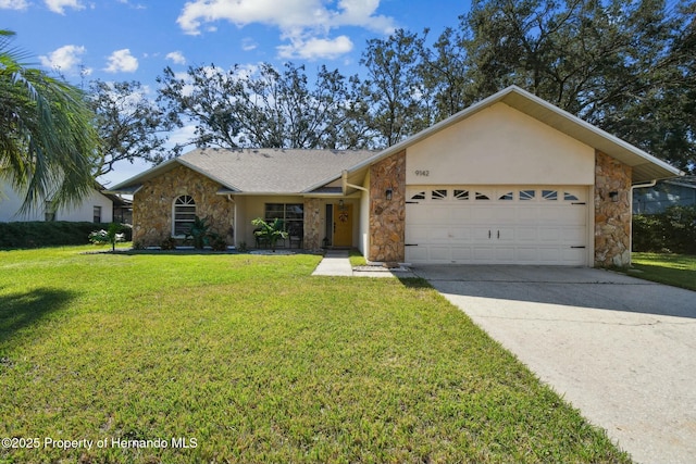 view of front of property featuring stone siding, an attached garage, driveway, and a front yard