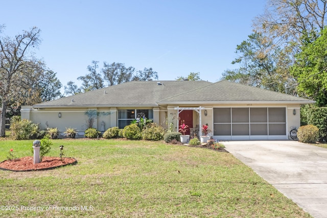 ranch-style house featuring driveway, a shingled roof, an attached garage, a front lawn, and stucco siding