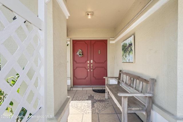 property entrance with stucco siding