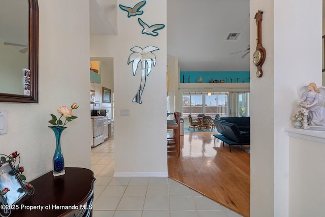 entrance foyer with ceiling fan, baseboards, visible vents, and tile patterned floors