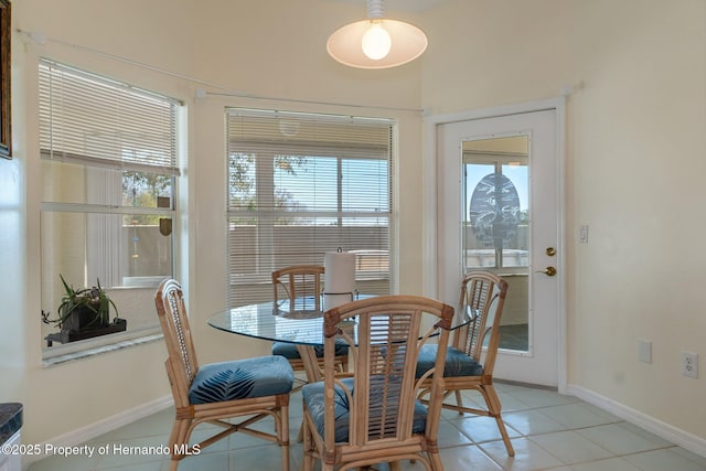 dining space with light tile patterned floors and baseboards