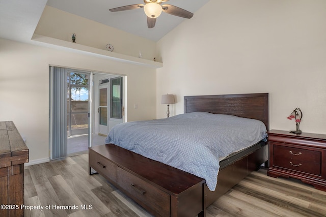 bedroom with baseboards, a ceiling fan, lofted ceiling, access to exterior, and light wood-type flooring