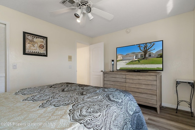 bedroom with ceiling fan and wood finished floors