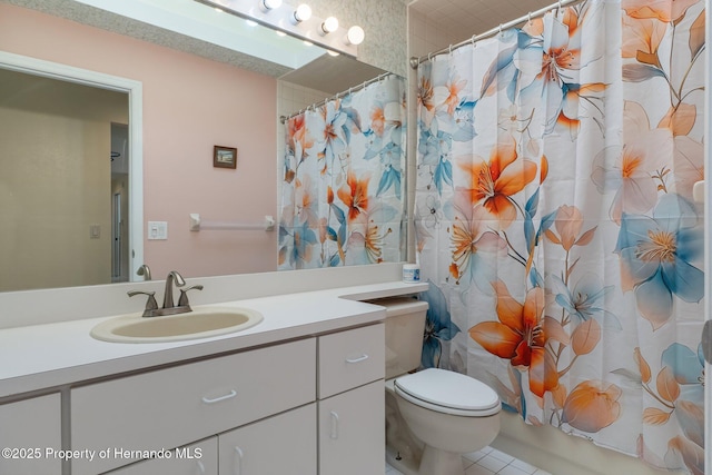 bathroom with toilet, curtained shower, and vanity