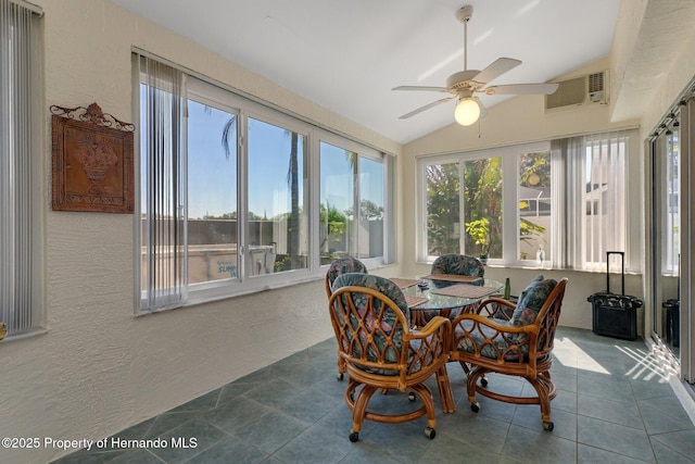 sunroom / solarium with a wall unit AC, vaulted ceiling, and ceiling fan