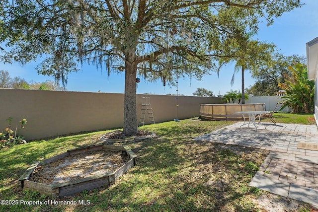 view of yard featuring a patio area and a fenced backyard