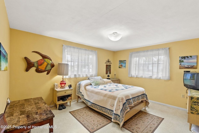 bedroom featuring multiple windows and baseboards