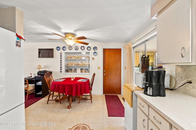 dining area featuring a ceiling fan and light tile patterned floors