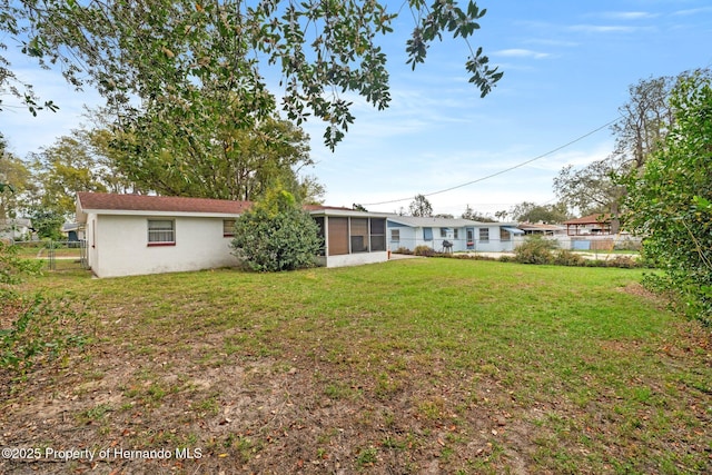 view of yard with fence and a sunroom