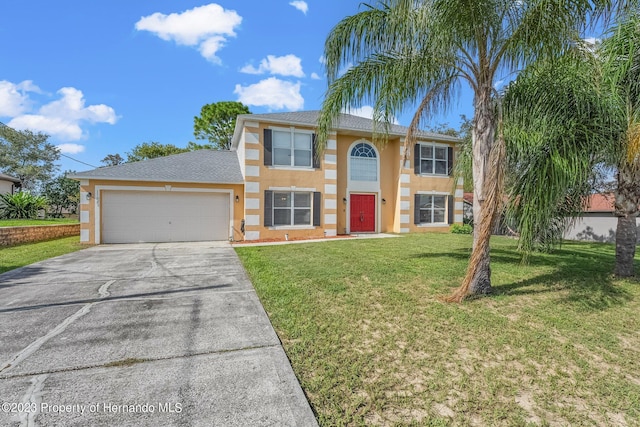 view of front of property featuring an attached garage, driveway, a front lawn, and stucco siding