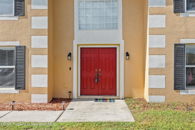 property entrance featuring stucco siding