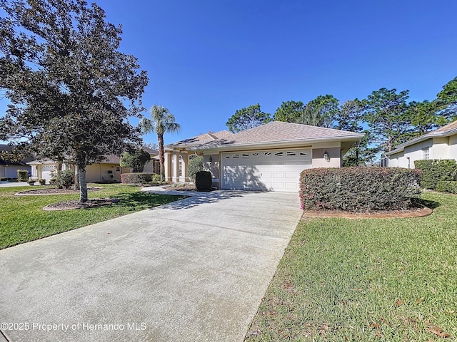 single story home featuring an attached garage, stucco siding, driveway, and a front yard