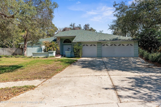 single story home with a garage, driveway, a front lawn, and fence