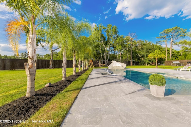 view of swimming pool with a fenced in pool, a fenced backyard, a lawn, and a patio