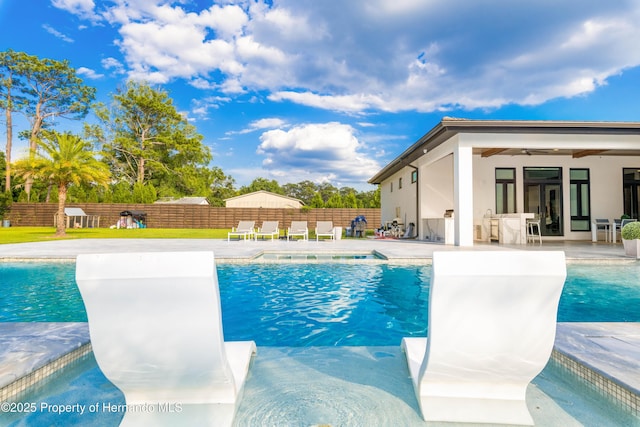 view of pool with a fenced backyard, ceiling fan, a fenced in pool, and a patio