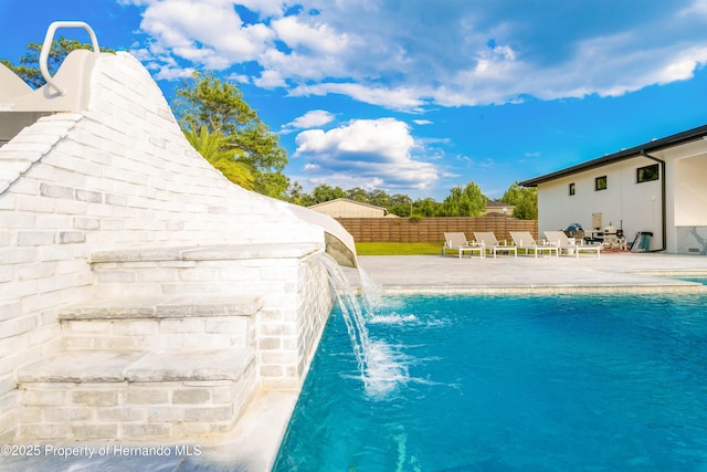 view of pool with fence, a fenced in pool, and a patio