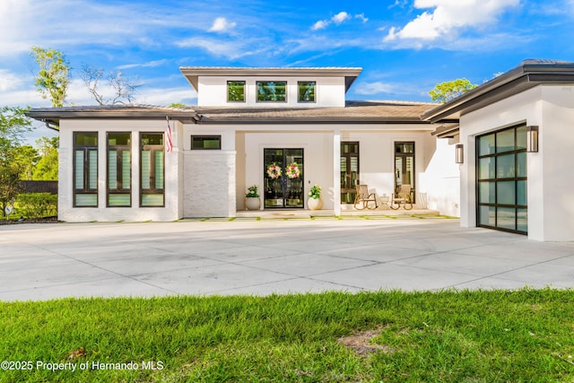 exterior space with a tile roof and stucco siding