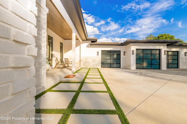 exterior space with concrete driveway and an attached garage