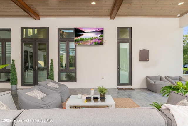 entrance to property with stucco siding, an outdoor hangout area, a patio, and french doors