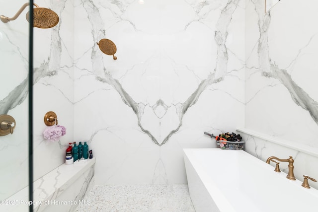 full bathroom featuring a tub to relax in and a marble finish shower