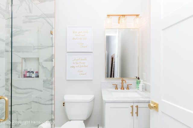 full bath with toilet, a stall shower, and vanity