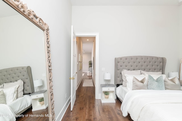 bedroom with baseboards and wood finished floors