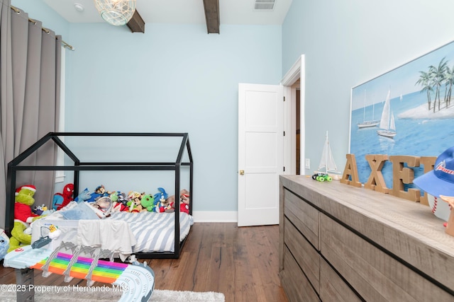 bedroom with dark wood-style floors, baseboards, visible vents, and beam ceiling