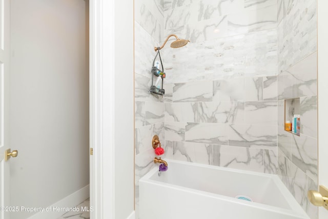 bathroom featuring shower / washtub combination and baseboards