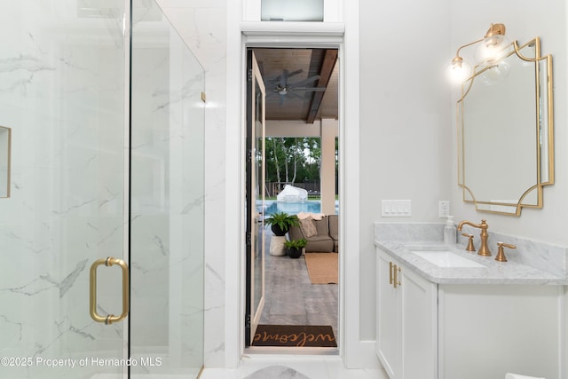 ensuite bathroom with ensuite bathroom, a marble finish shower, and vanity