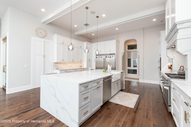 kitchen featuring a spacious island, tasteful backsplash, high end appliances, and dark wood-type flooring